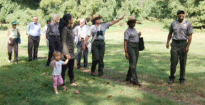 Ranger Maggie (arm raised) leads the bird walk